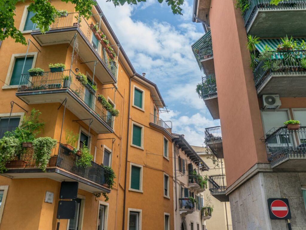 Palazzi residenziali con balconi fioriti e persiane alle finestre